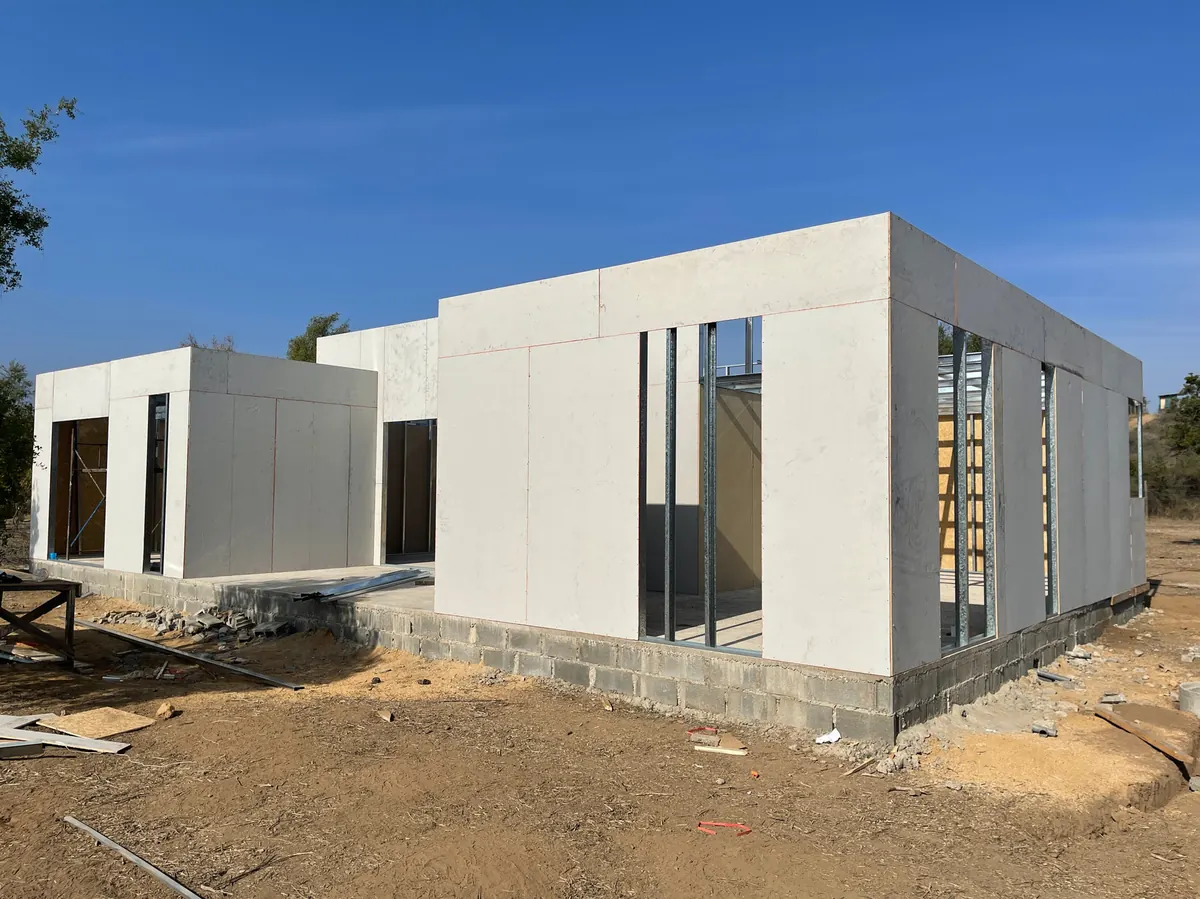 Casa Mediterráneo en obra gruesa, vista lateral con vanos de ventanas